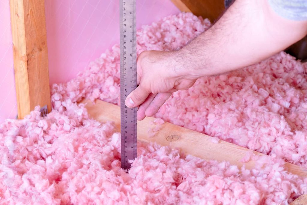 Measuring the insulation depth to make sure it's not too much.